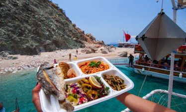 Fresh BBQ lunch being served onboard during the Suluada boat trip