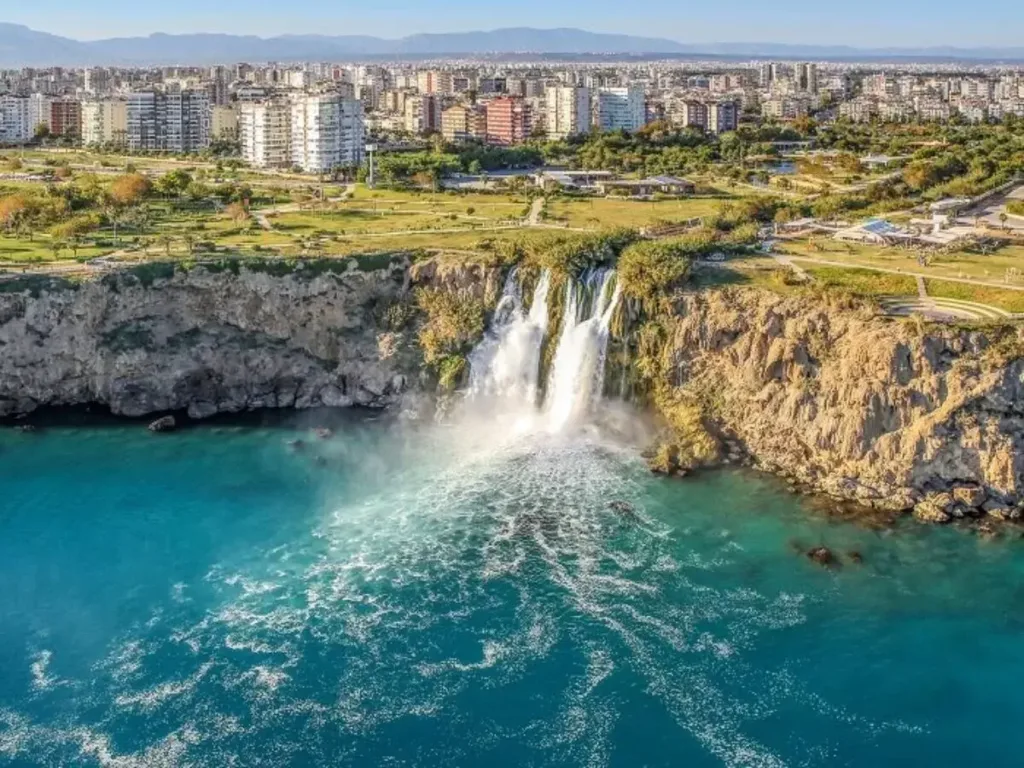 Lower Düden Waterfall dropping 40 metres from Antalya cliffs into the Mediterranean Sea, seen from a boat