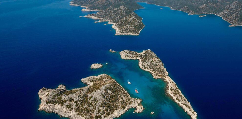 Aerial view of Kekova sunken city and turquoise coastline from hilltop