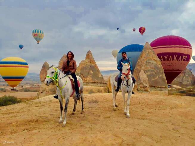 Couple enjoying a love-filled horse ride through the breathtaking valleys of Cappadocia