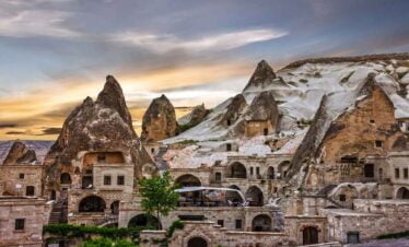Snow-covered Göreme Open Air Museum in Cappadocia with ancient rock churches.