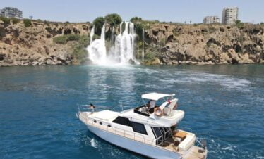Luxury yacht cruising near the stunning waterfalls of Lara, Antalya