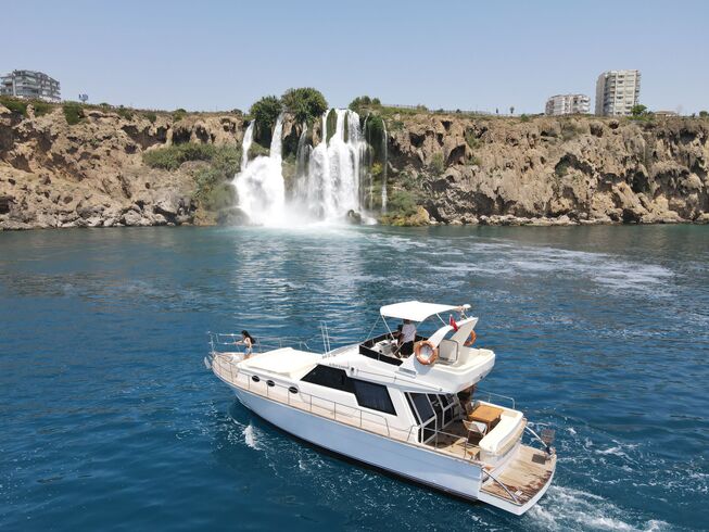 Luxury yacht cruising near the stunning waterfalls of Lara, Antalya