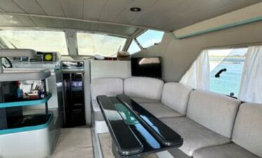 Spacious saloon of a luxury yacht, featuring elegant furniture and sea views