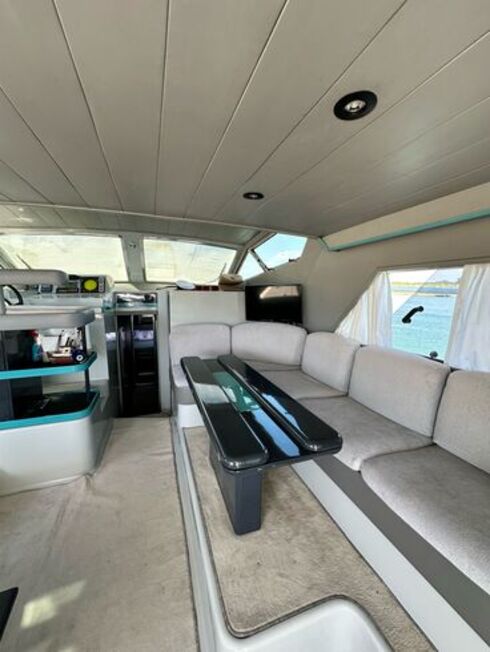 Spacious saloon of a luxury yacht, featuring elegant furniture and sea views