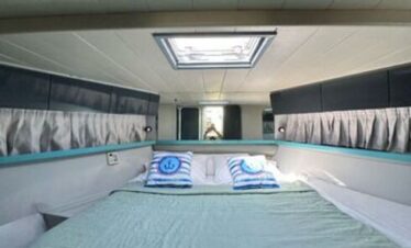 Double bed in a luxury yacht cabin, offering comfort and stunning sea views
