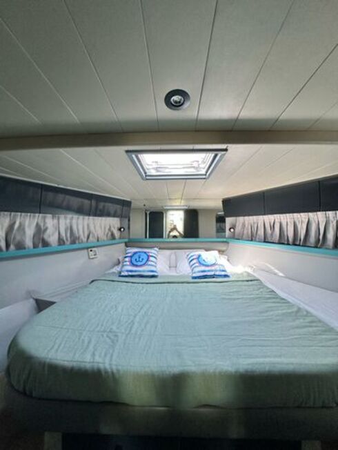 Double bed in a luxury yacht cabin, offering comfort and stunning sea views