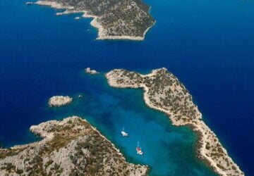 Aerial view of Kekova sunken city and turquoise coastline from hilltop