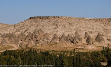Row of fairy chimneys (Peri Bacaları) in Cappadocia, resembling mountains with unique rock formations
