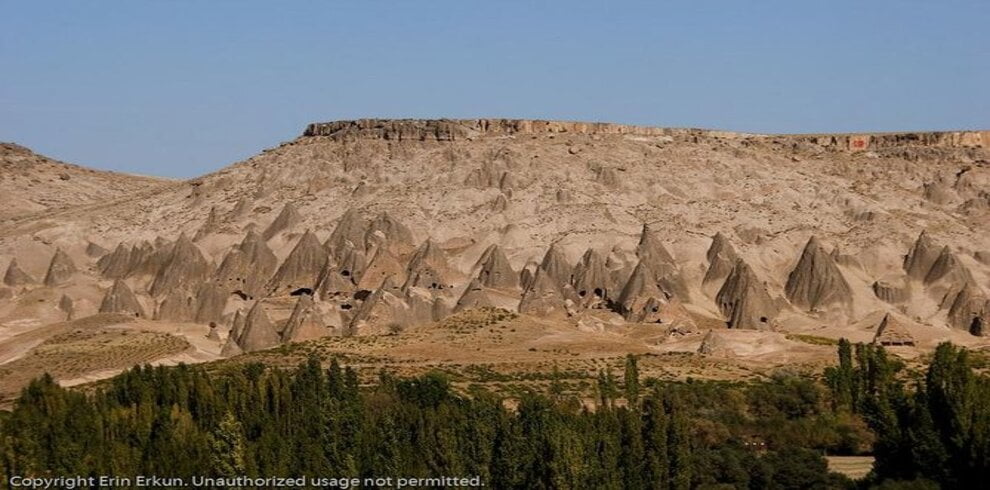 Row of fairy chimneys (Peri Bacaları) in Cappadocia, resembling mountains with unique rock formations