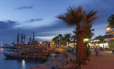 Side harbor with boats docked along the Mediterranean coastline