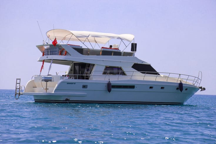 Luxury motor yacht cruising in Kemer, Antalya, offering a scenic Mediterranean tour