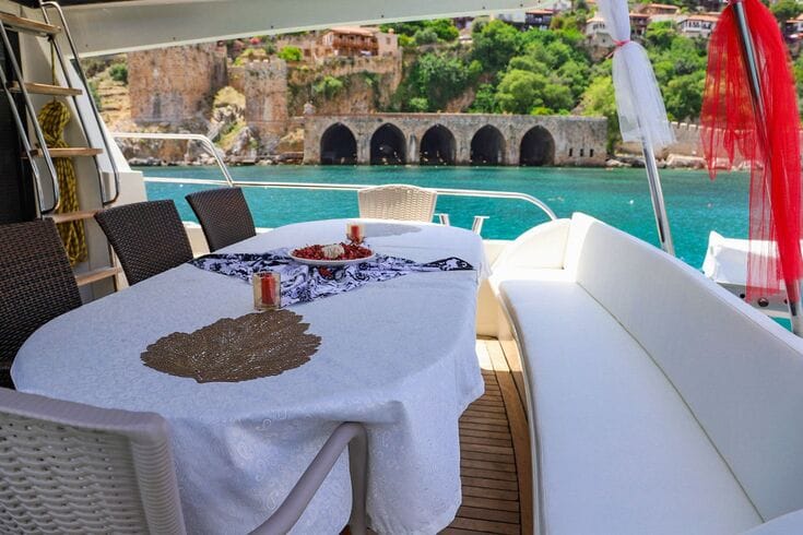 Dining table with delicious meal aboard a luxury yacht in Alanya