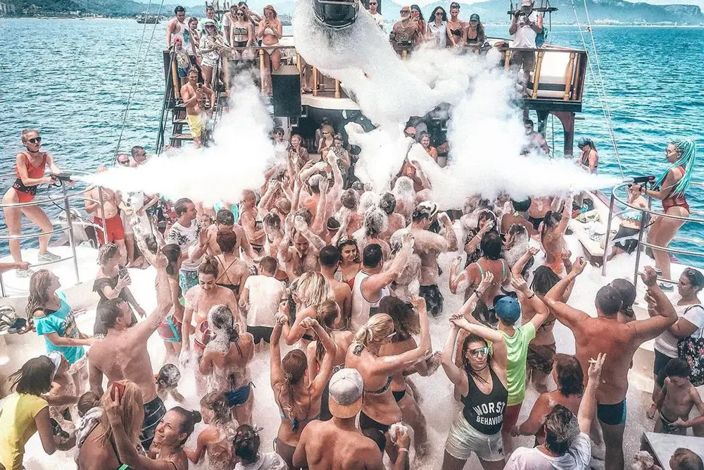 Guests dancing at foam party on Gongster pirate ship near Antalya