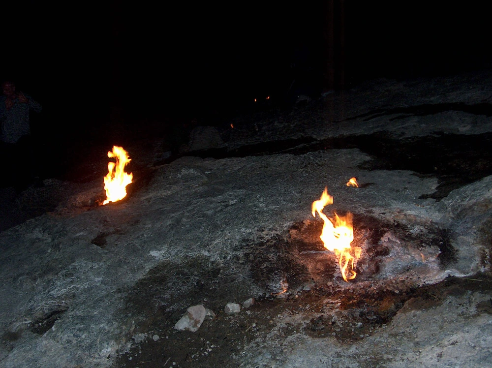 Eternal flames of Chimera burning at night near Olympos in Antalya Turkey