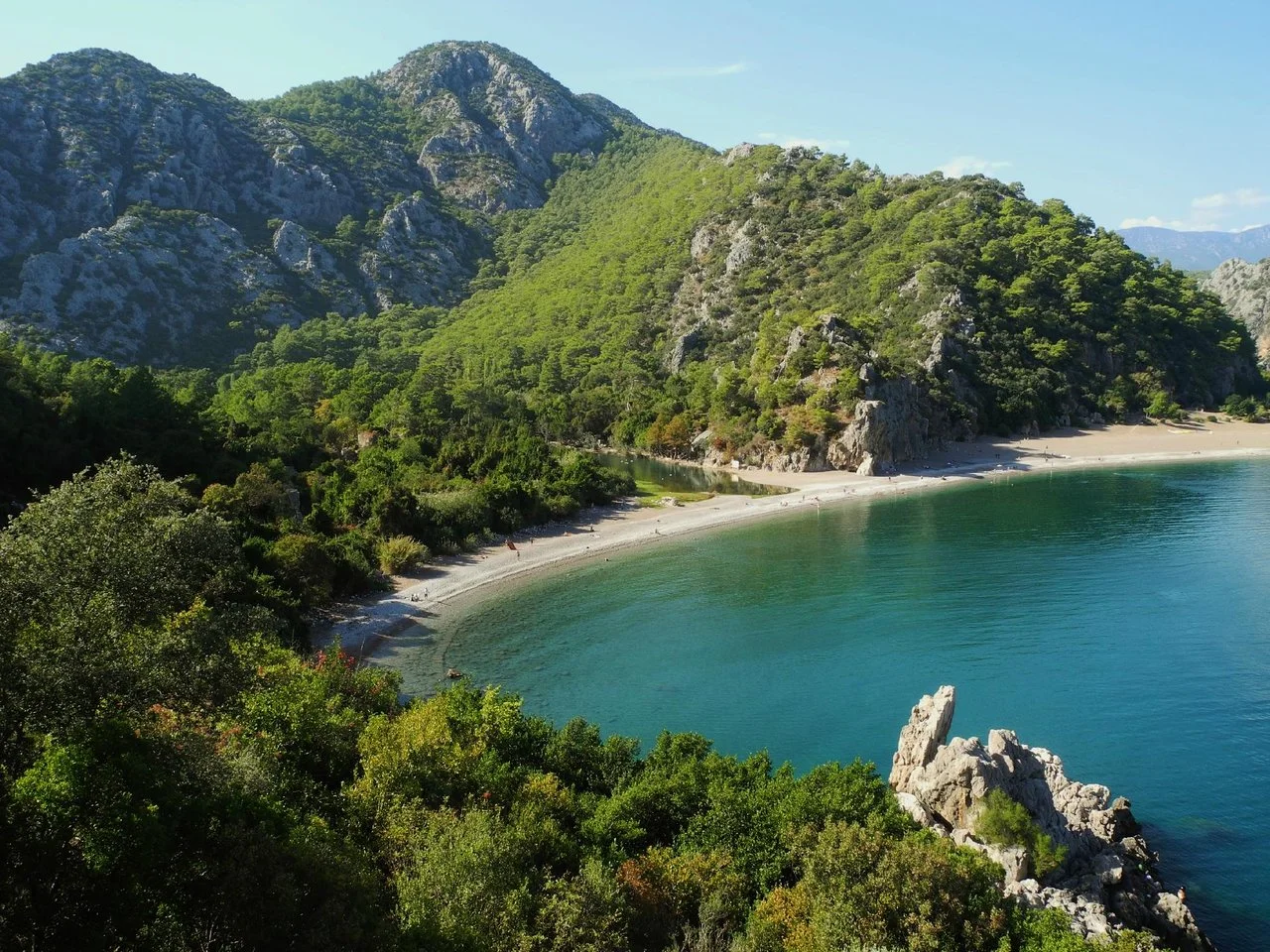 Ancient ruins of Olympos in Antalya surrounded by green forest and historical stone arches