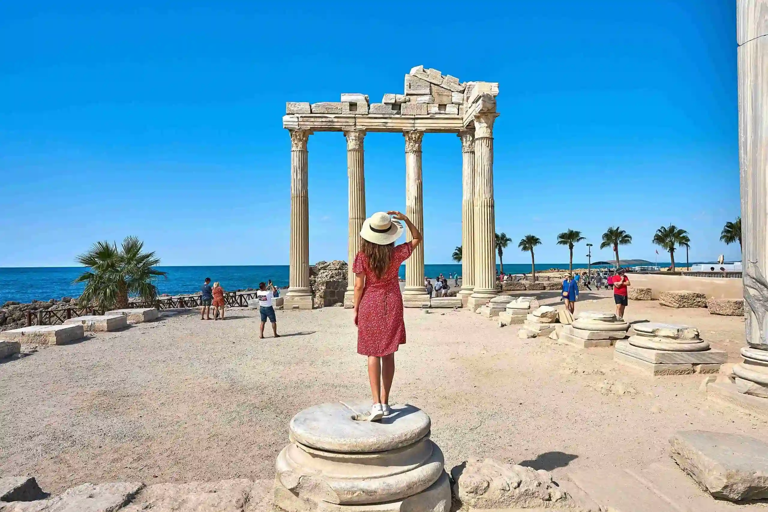 tourist posing at the ancient Apollo Temple in Side during one of the best history tours in Antalya.